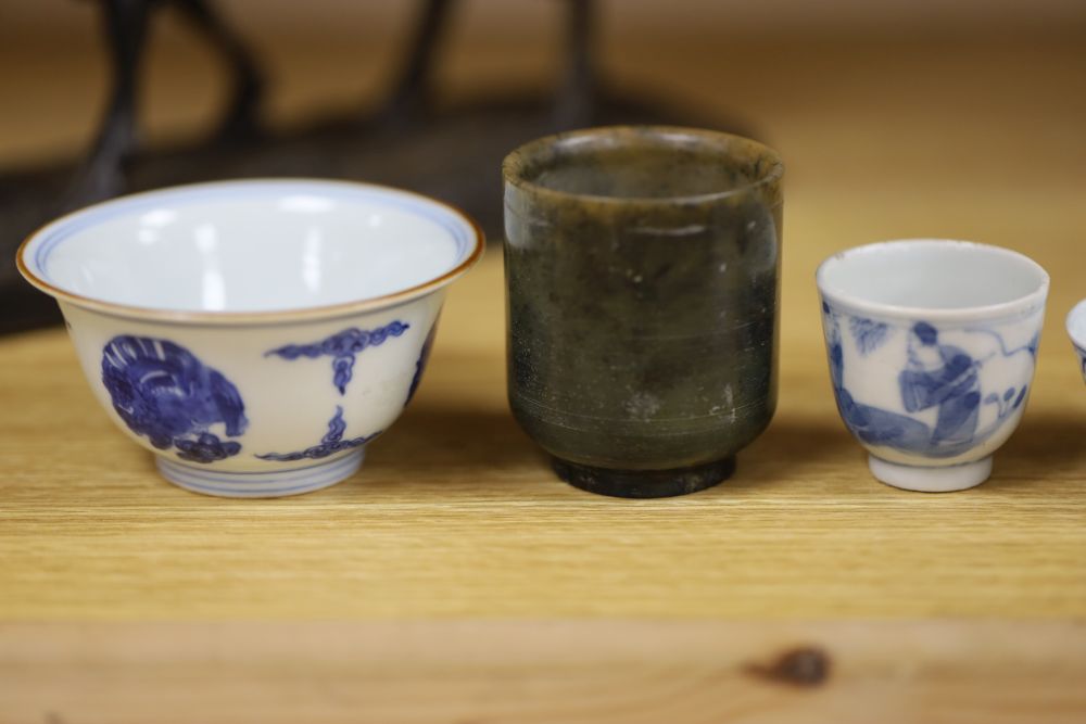 A group of Chinese cups, four ceramics, one jade and some have marks